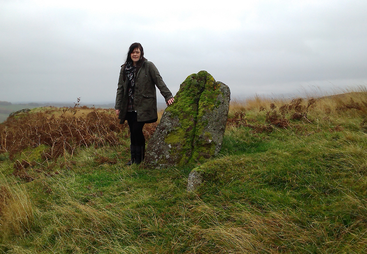 Lisa standing with the old stone