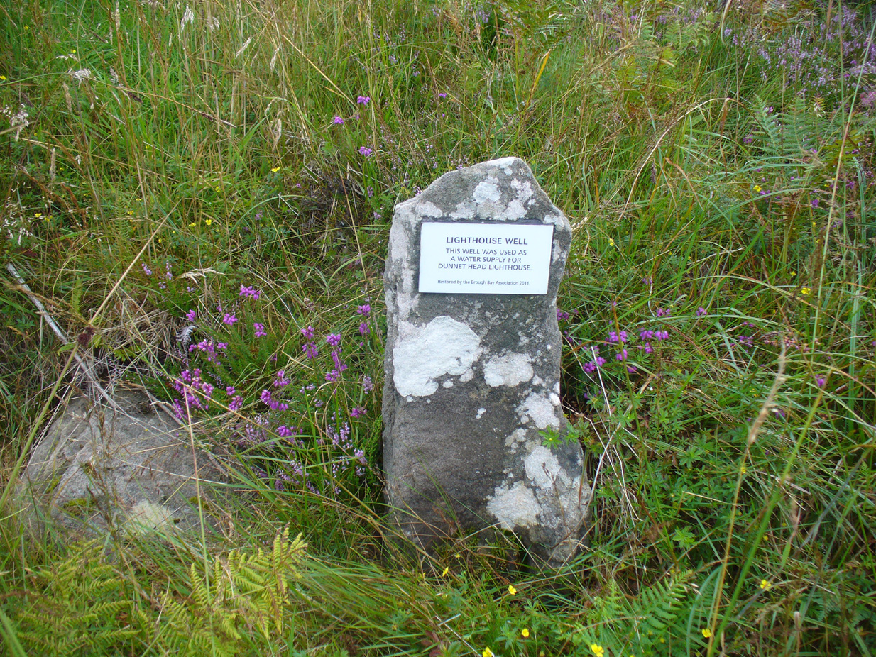 Stone & plaque by its side